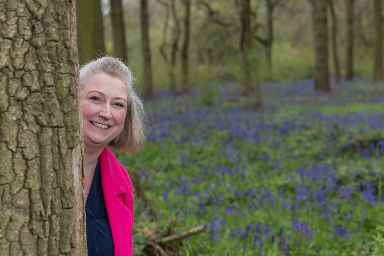 Jody hiding behind a tree while enjoying a countryside walk